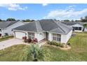 Single-story house with a gray roof and a spacious backyard at 603 San Pedro Dr, Lady Lake, FL 32159