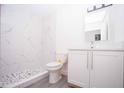 Modern bathroom with white cabinets, marble shower, and pebble floor at Lot 17 Indian Estates Cr 423, Lake Panasoffkee, FL 33538