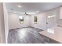 Bright living room with wood-look flooring, recessed lighting, a ceiling fan and natural light from windows at Lot 17 Indian Estates Cr 423, Lake Panasoffkee, FL 33538