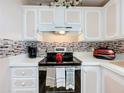 Modern electric range and updated backsplash in this kitchen at 1559 Nassau Cir, Tavares, FL 32778