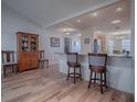 Welcoming foyer with wood floors, a glass front door, a decorative table, and elegant accents at 17242 Se 94Th Coults Cir, The Villages, FL 32162