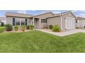 Tan house with a walkway and landscaping at 17466 Se 75Th Coachman Ct, The Villages, FL 32162