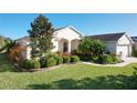 One-story home with landscaped yard and two-car garage at 27103 Camerons Run, Leesburg, FL 34748
