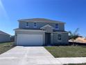 Charming two-story home with a two-car garage, freshly landscaped yard and welcoming front entrance at 2833 Supermarine Rd, Tavares, FL 32778