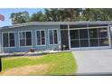 Charming home featuring a screened-in porch and well-manicured front yard with rock landscaping at 30 Riverview Dr, Fruitland Park, FL 34731