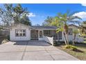 Charming bungalow exterior with landscaped yard and spacious driveway at 422 W 11Th Ave, Mount Dora, FL 32757