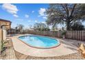 Enjoy the backyard's inviting pool with a paved deck, perfect for outdoor entertaining and relaxation at 5640 Se 21St Ln, Ocala, FL 34480