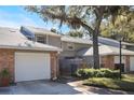 Two-story townhome with brick facade and a private fenced patio at 624 Maple Oak Cir # 108, Altamonte Springs, FL 32701