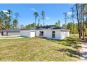 View of a modern single-story home with a two-car garage and well-kept lawn at 91 Locust Loop, Ocala, FL 34472