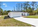A modern single-story home with a two-car garage and a concrete driveway at 91 Locust Loop, Ocala, FL 34472