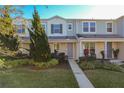 Front view of charming two-story townhome with walkway at 1306 Painted Bunting Ave, Oakland, FL 34787