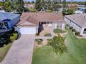 Single-story home with a brick driveway and well-maintained lawn at 16914 Se 96Th Chapelwood Cir, The Villages, FL 32162