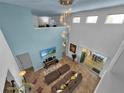 Bright living room featuring soaring ceilings, tile flooring, a modern chandelier and neutral decor at 9249 Ivywood St, Clermont, FL 34711