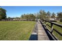 Community dock and boat slips in a waterfront neighborhood with lush, green lawn at 1018 Green Gate Blvd, Groveland, FL 34736