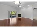 Bright living room with hardwood floors, fireplace, and sliding doors leading to a patio at 1018 Green Gate Blvd, Groveland, FL 34736