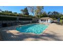 Beautiful community pool with sun loungers, umbrellas, and a bath house for residents to enjoy at 1018 Green Gate Blvd, Groveland, FL 34736
