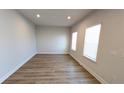 Bright and airy living room with light walls and wood-look flooring at 1710 Summer Rose Dr, Mount Dora, FL 32757