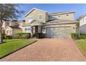 Two-story house with brick driveway and landscaped lawn at 1741 Bonser Rd, Minneola, FL 34715