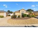 Well-maintained home featuring a landscaped yard with decorative rocks and shrubbery at 2169 Smoaks St, The Villages, FL 32162