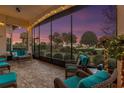 Relaxing screened porch with comfortable seating and string lights at 38626 Lakeview Walk, Lady Lake, FL 32159