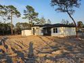 Beautiful modern home with sleek design, large windows, and lush landscaping at 42200 Chinaberry St, Eustis, FL 32736