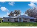 Tan house with gray roof, white trim, and landscaping; daytime photo at 5622 King James Ave, Leesburg, FL 34748