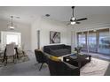 Bright living room with dining area, and access to a screened porch at 5622 King James Ave, Leesburg, FL 34748