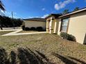 Side view of a house showcasing a walkway and landscaping at 61 Fir Dr, Ocala, FL 34472