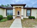 Inviting front entrance with covered porch and walkway at 61 Fir Dr, Ocala, FL 34472