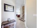 Bright and airy entryway with stairs to the second floor and views to the living area at 765 Walkers Grove Ln, Winter Garden, FL 34787