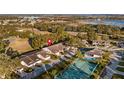 Aerial view showcasing the home's location in a community with tennis courts and a pool at 8801 Village Green Blvd, Clermont, FL 34711