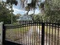 House with a wrap around porch and black gate at 110 N Volusia Ave, Pierson, FL 32180