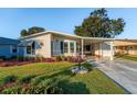 Single-story home with carport and well-maintained yard at 1121 Paradise Dr, Lady Lake, FL 32159