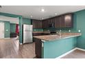 Kitchen with breakfast bar and stainless steel appliances at 12066 Callicarpa Ln, Leesburg, FL 34788