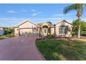 One-story home with attached garage and landscaped yard at 17112 Se 71St Lewisfield Ter, The Villages, FL 32162