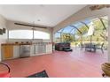 Outdoor kitchen with stainless steel appliances and hot tub at 17112 Se 71St Lewisfield Ter, The Villages, FL 32162