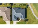 Overhead view of a home with lush lawn and manicured landscape bordering the golf course at 17350 Se 116Th Court Rd, Summerfield, FL 34491