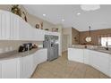 Spacious kitchen with white cabinets, granite countertops, and stainless steel appliances at 17716 Se 85Th Ellerbe Ave, The Villages, FL 32162