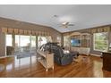 Bright living room featuring hardwood floors, comfortable seating, and a view of the patio at 17716 Se 85Th Ellerbe Ave, The Villages, FL 32162