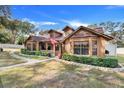 Two-story home with brick and wood siding at 18033 Rose St, Groveland, FL 34736