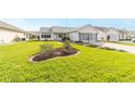 Neatly landscaped front yard with a spacious lawn at 1904 De Hoyos Pl, The Villages, FL 32159