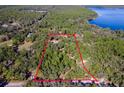 Property view showcasing a large lot with mature trees near the lake at 19315 Dorr Rd, Altoona, FL 32702