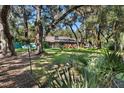 Log home nestled in a wooded setting with a large backyard at 19315 Dorr Rd, Altoona, FL 32702