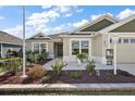 House exterior showcasing a landscaped front yard and welcoming entryway at 2030 Chaires Pl, The Villages, FL 34762