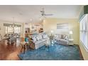 Bright living room with hardwood floors, comfy sofas, and a ceiling fan at 2486 Five Forks Trl, The Villages, FL 32162