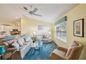 Living room with hardwood floors, neutral-toned furniture, and a ceiling fan at 2486 Five Forks Trl, The Villages, FL 32162