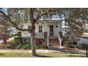 Charming front porch with brick accents, inviting entry and beautiful landscaping at 2746 Se 19Th Ct, Ocala, FL 34471