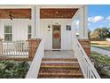 Inviting front porch with brick steps and a wooden ceiling at 2746 Se 19Th Ct, Ocala, FL 34471