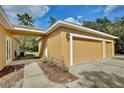 Three-car garage with additional covered walkway at 30629 Alder Ave, Eustis, FL 32736
