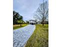 Long paved driveway leading to a two-story house at 3180 Sixma Rd, Lake Helen, FL 32744
